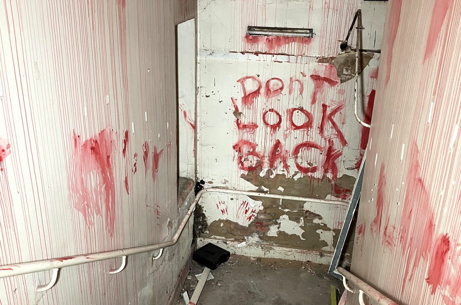 An urban explorer found a derelict museum filled with blood red warnings and a pentagram on the floor describing the eerie abandoned site as something straight out of a horror film.