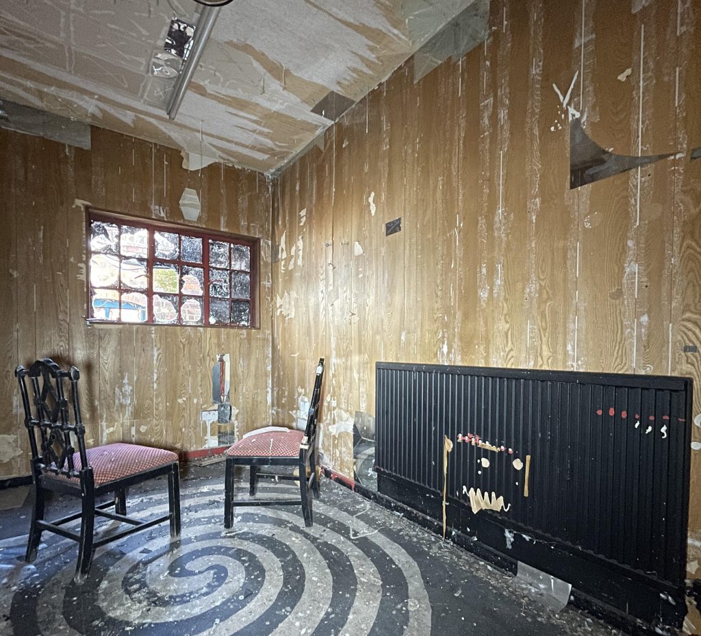 An urban explorer found a derelict museum filled with blood red warnings and a pentagram on the floor describing the eerie abandoned site as something straight out of a horror film.
