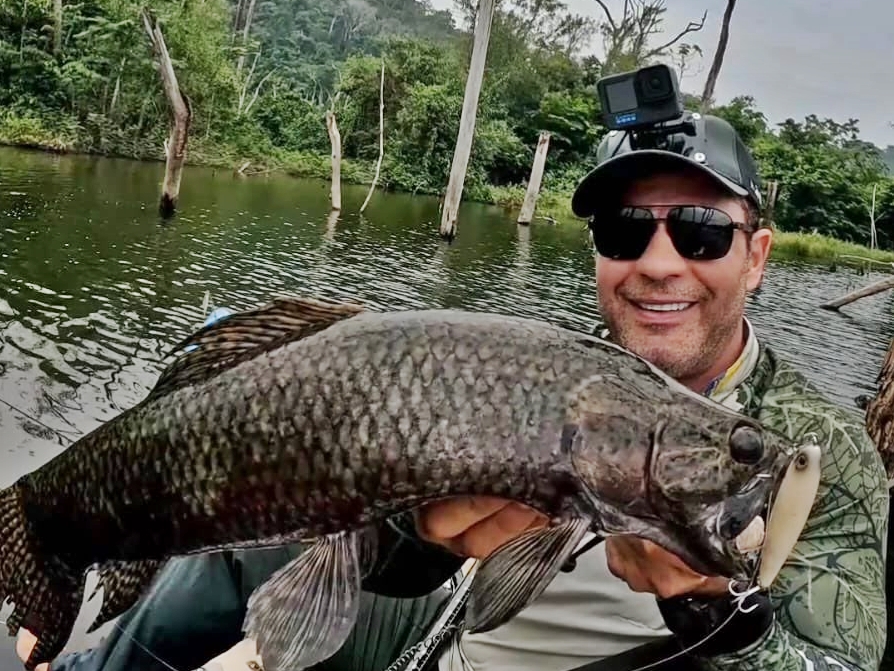 Piranhas devoured a fish moments after it was hooked in the Amazon leaving only its head as stunned anglers bizarrely decided to eat the remains raw in a survival style meal.