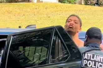 An escaped convicted murderer who was on the run for five months has been recaptured in Atlanta, Georgia, and stunned onlookers by blowing a kiss as he was led into a police car.