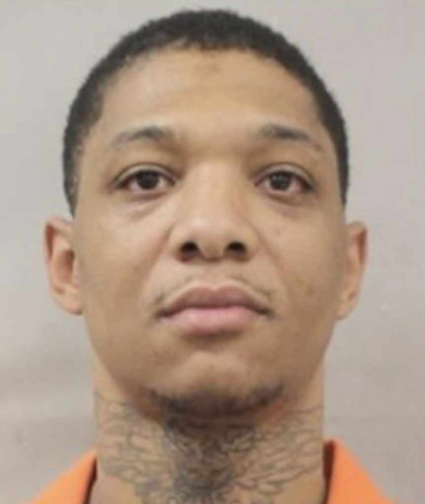 An escaped convicted murderer who was on the run for five months has been recaptured in Atlanta, Georgia, and stunned onlookers by blowing a kiss as he was led into a police car.