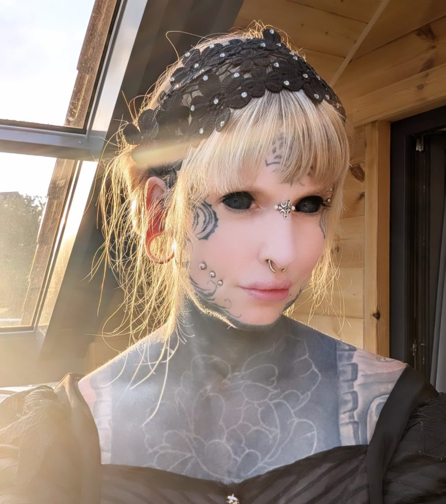 Tattoo artist Heidi Zitna from Munich has spent £17,500 transforming herself with inked eyes, piercings and skull implants, calling her body a living work of art.