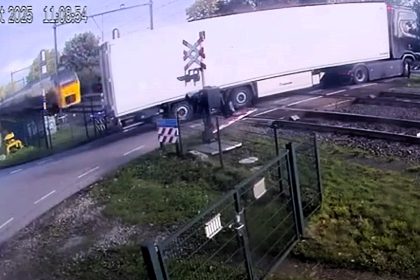 A speeding train ploughed into a lorry loaded with pears in the Netherlands after the driver reversed onto a level crossing and got stuck destroying a kilometre of track.