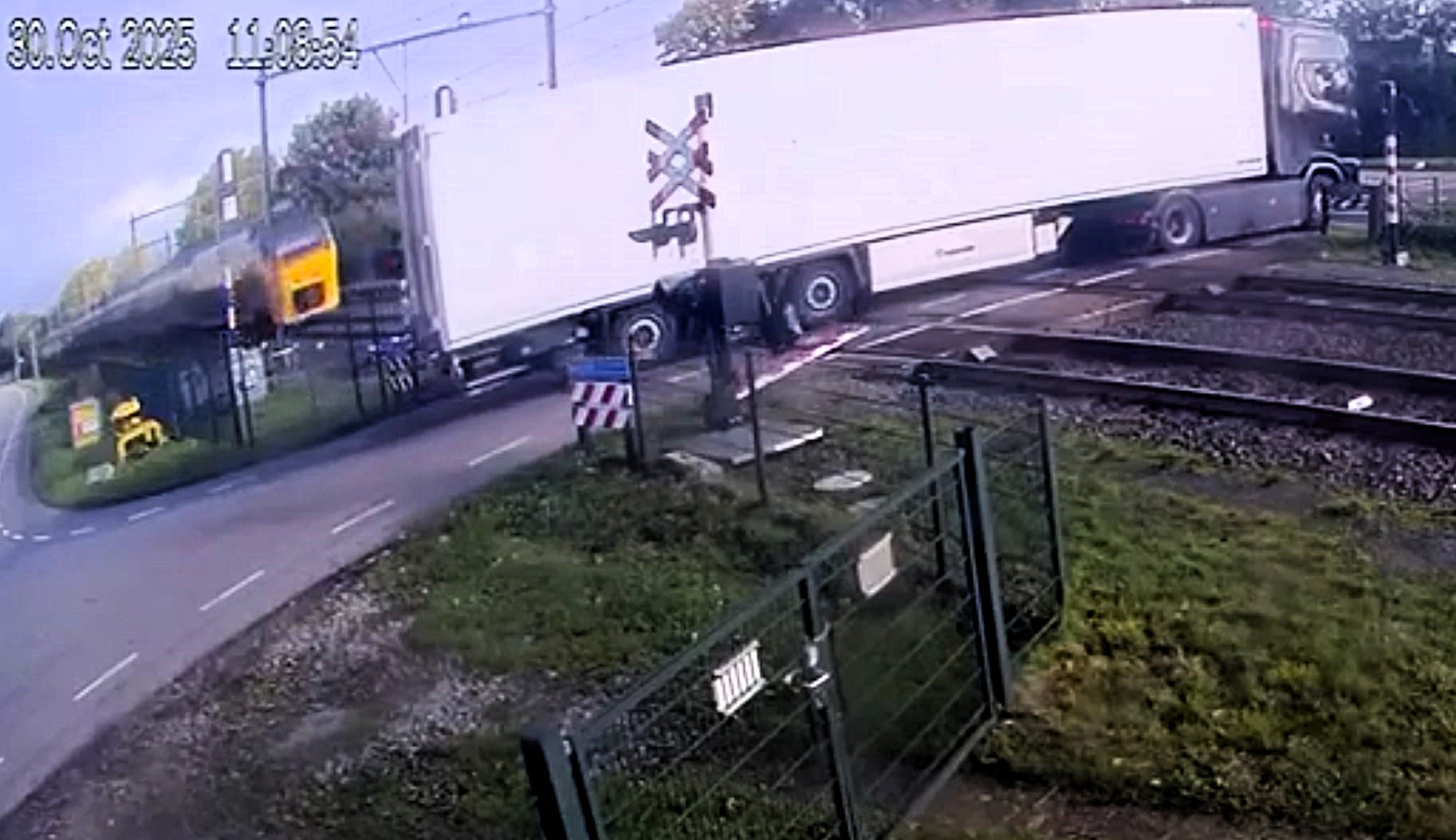 Train slams into fruit-loaded lorry after bungling driver reverses on ...