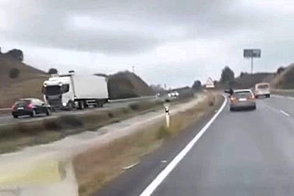 Wrong way driver causes head on crash on Spain’s AP7 motorway leaving five people injured including one seriously as shocking footage shows the black hatchback driving straight into traffic.