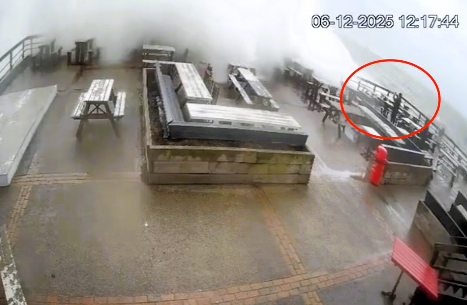 Storm Bram sends a massive wave crashing over a coastal pub drenching beer garden drinkers and sweeping furniture as The Inn on The Beach warns visitors to enjoy the weather at their own risk.