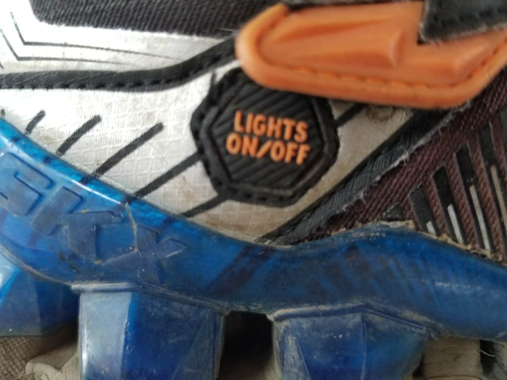 Mum warns parents before Christmas after light up shoes leaked battery acid on her sons feet, causing second degree burns and lasting nerve damage after getting wet at school.