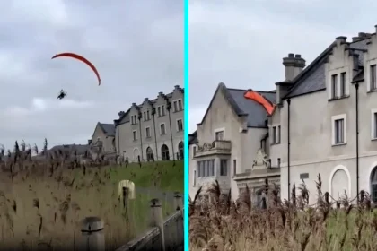 A paraglider crashed into a hotel roof in Northern Ireland after flying just feet above the ground and hitting a chimney, with the injured man taken to hospital following the incident.