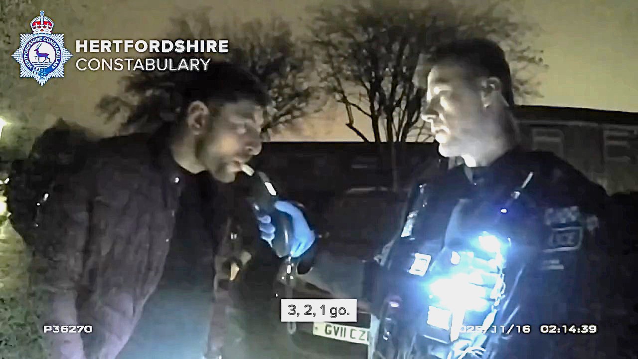 Drink driver caught staggering from car is arrested after blowing over three times the legal limit as CCTV operator alerts police following pub visit in Hertfordshire.
