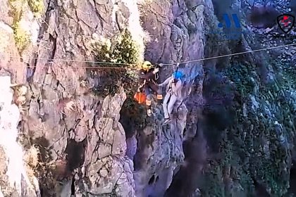 Firefighter rescues man stuck on zip line 70m above reservoir near Ronda, Spain popular with Brits - performs mid-air rescue using arm strength, winches both to safety.