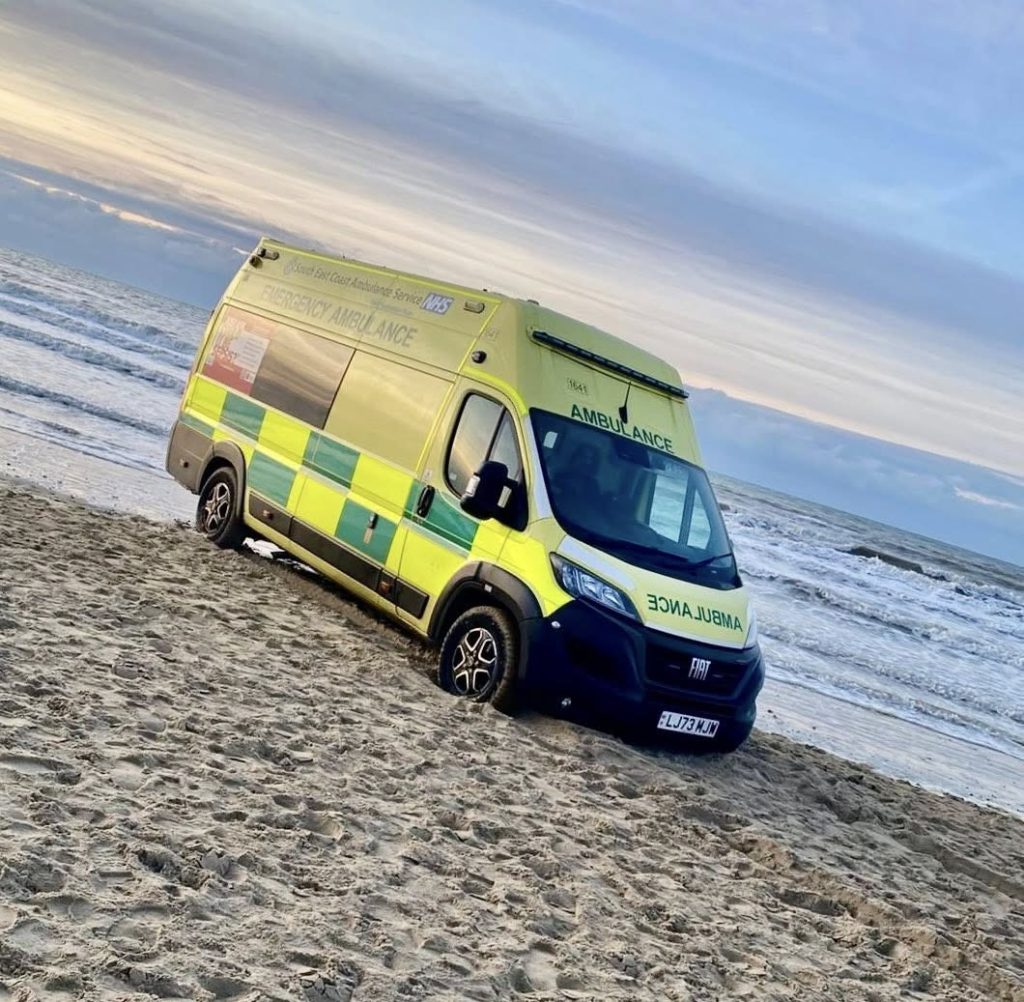 Ambulance with patient inside trapped by rising tide at Camber Sands beach on New Year's Day required off-road recovery vehicle rescue as waves reached its wheels.