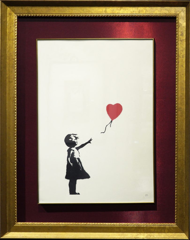 Collection of 13 Banksy prints including iconic Girl with Balloon set to raise £300,000 at Heritage Auctions. Features Basquiat tribute and Pulp Fiction banana piece.