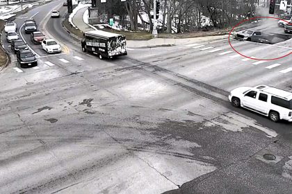 Two cars swallowed by horror sinkhole after road collapses in Omaha - drivers forced to climb out of deep shaft as SUV nearly disappears into the ground.
