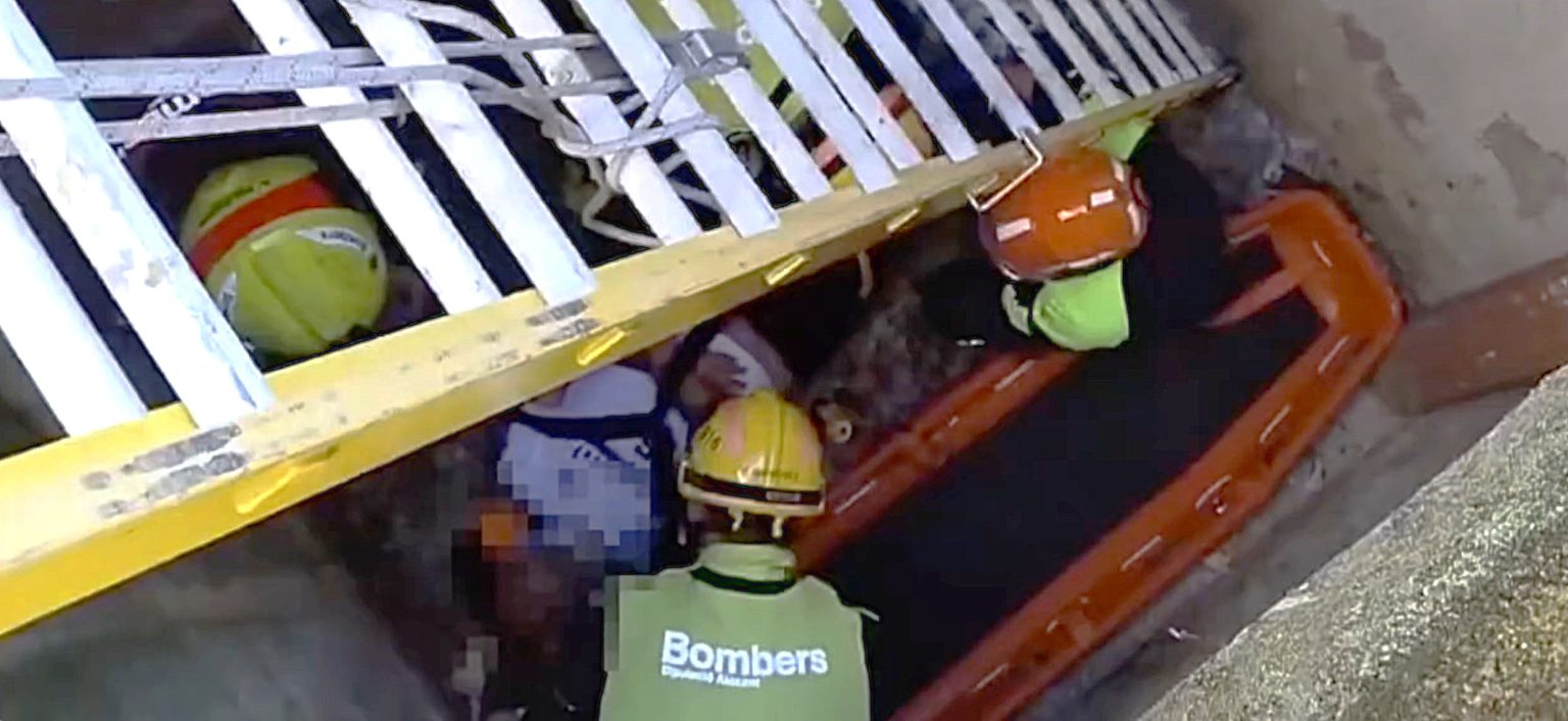 A cemetery worker plunged nearly 10ft into an open grave while cleaning a headstone in Spain - leaving him trapped with a serious back injury until firefighters lowered a ladder to pull him out.