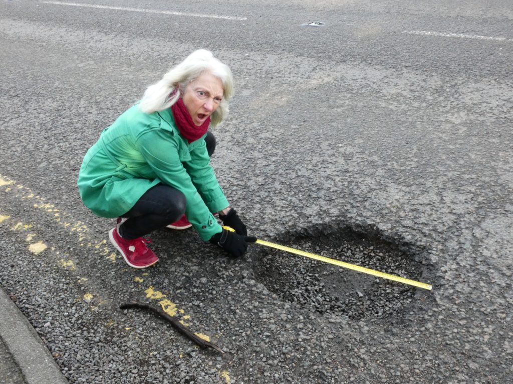 Woman wins 4-month battle to fix monster 7ft pothole after petition got 600 signatures. The huge chasm on A1301 was so big she could lie down in it and resembled a war zone.