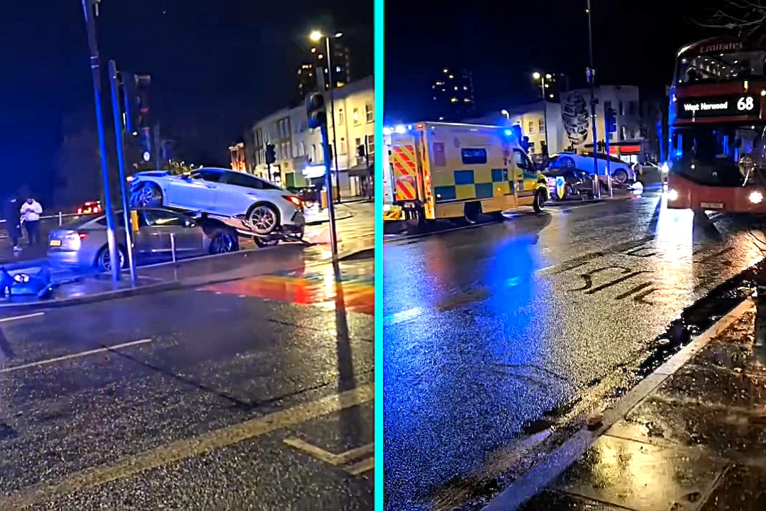 Horror crash at Herne Hill junction leaves silver car bizarrely perched on top of grey car. Emergency services attend shocking collision near Brixton rainbow crossing.