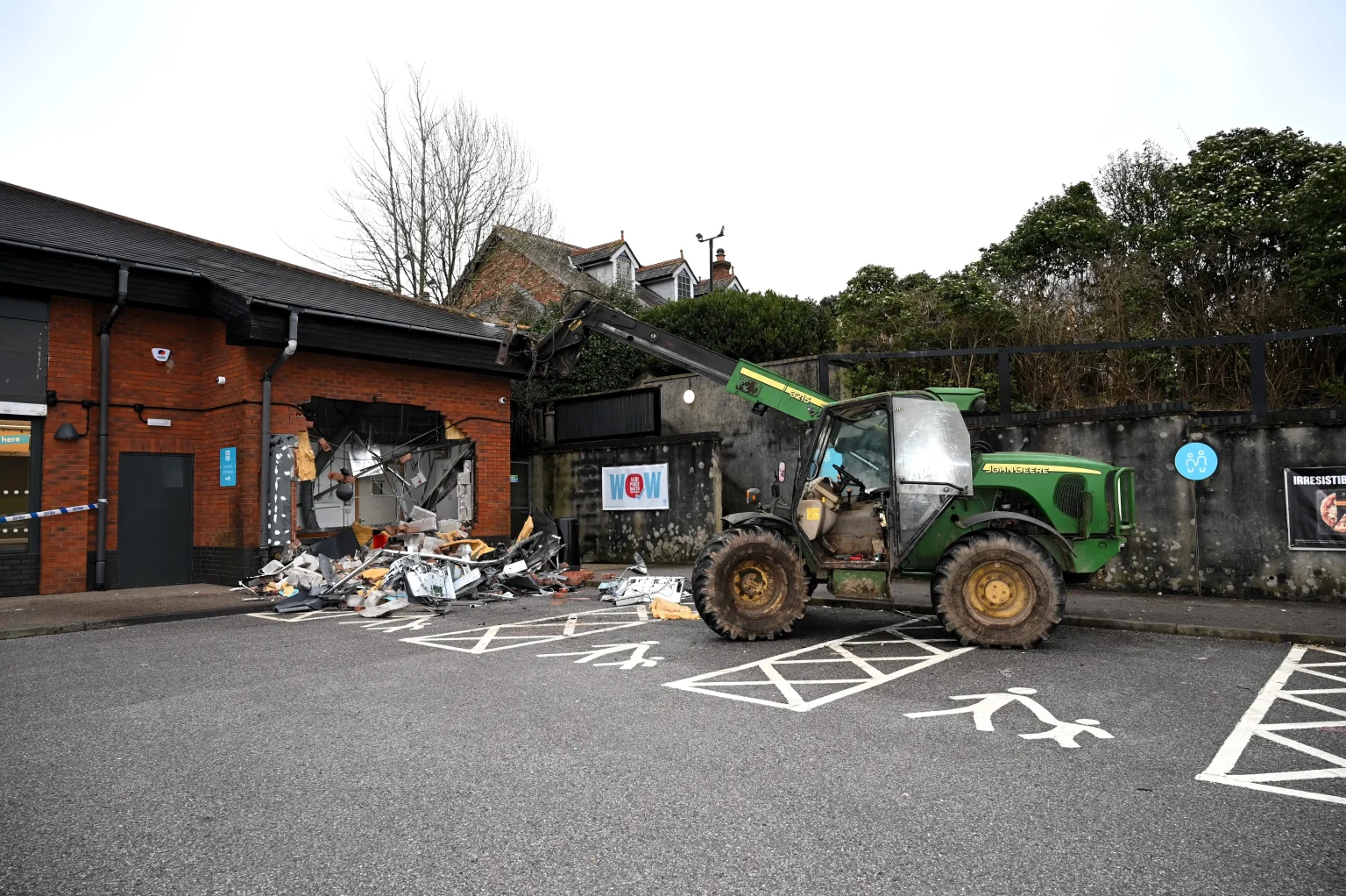 Ram raid gang uses stolen John Deere telehandler to smash into Co-op and steal cash point in Plympton, Devon. Sophisticated four-person gang linked to burglaries.