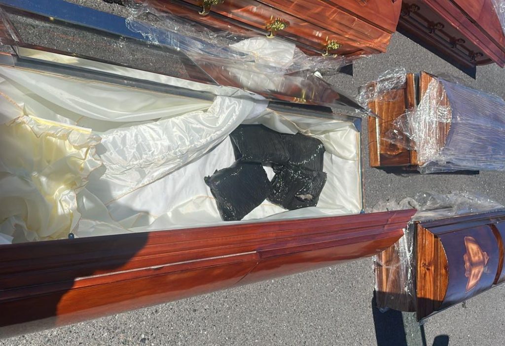 Police seize cannabis hidden inside a coffin after stopping a lorry carrying 23 caskets in Chile - three suspected drug traffickers arrested during routine roadside checks.