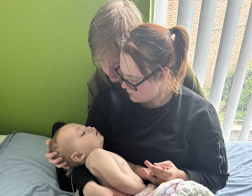 A 22-month-old girl with no Covid symptoms suddenly collapsed and was diagnosed with a rare brain condition - leaving her parents watching her tiny body "turn to stone" overnight.