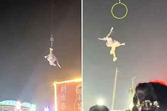 Horror footage shows an acrobat falling several metres after losing her grip on an aerial hoop suspended from a crane during a live performance in China's Henan province.