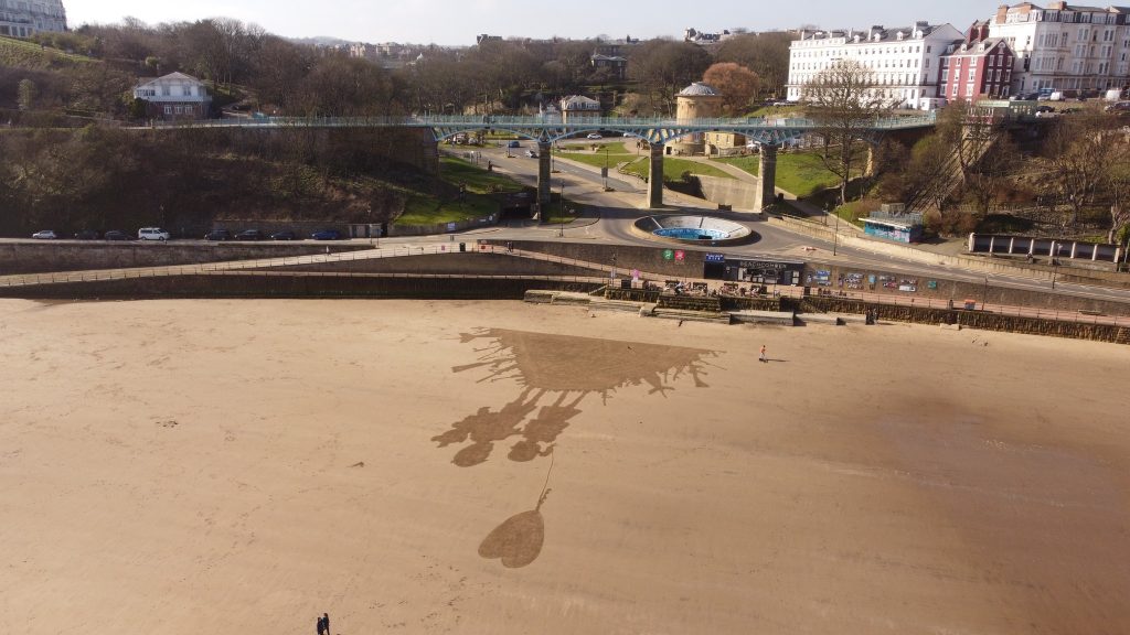 Artist Fred Brown recreates Banksy's iconic Kids on Guns artwork on Scarborough beach using just a rake - a powerful tribute amid global conflict that stunned visitors.