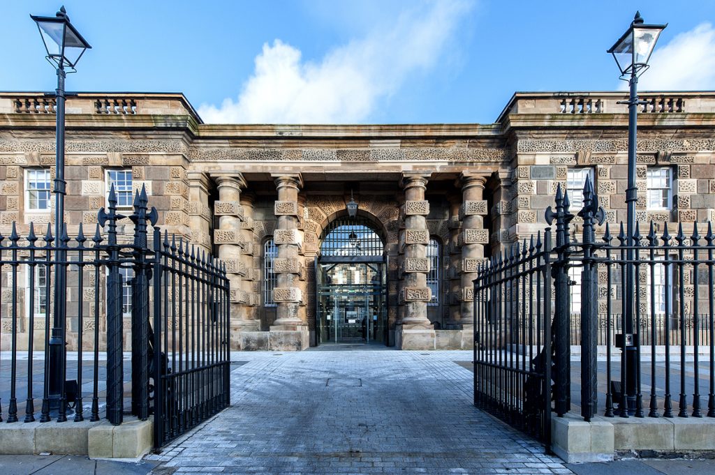 Spooky CCTV footage shows books flying off a shelf in an empty shop at a 150-year-old former jail where 15 prisoners are still buried within its walls.