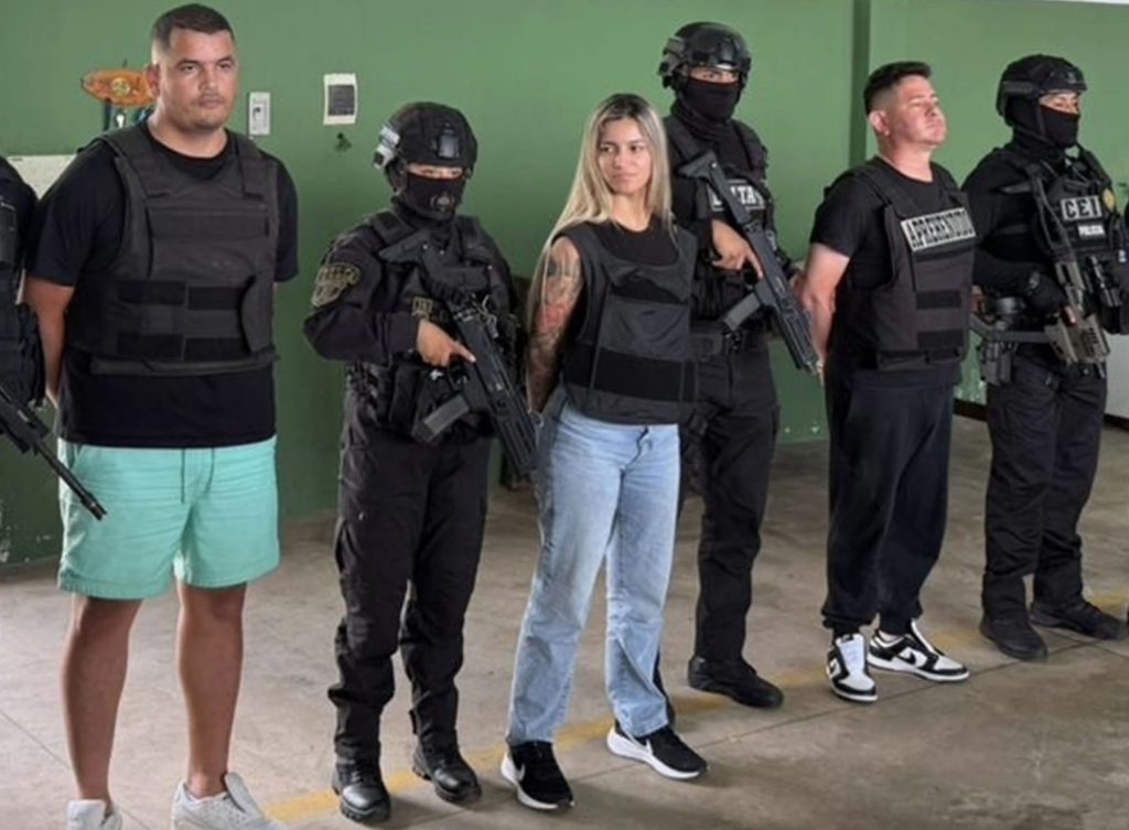 Glam narco suspect goes viral for smugly grinning in her arrest video - the 22-year-old is accused of being a senior member of her drug lord half-brother's criminal gang.