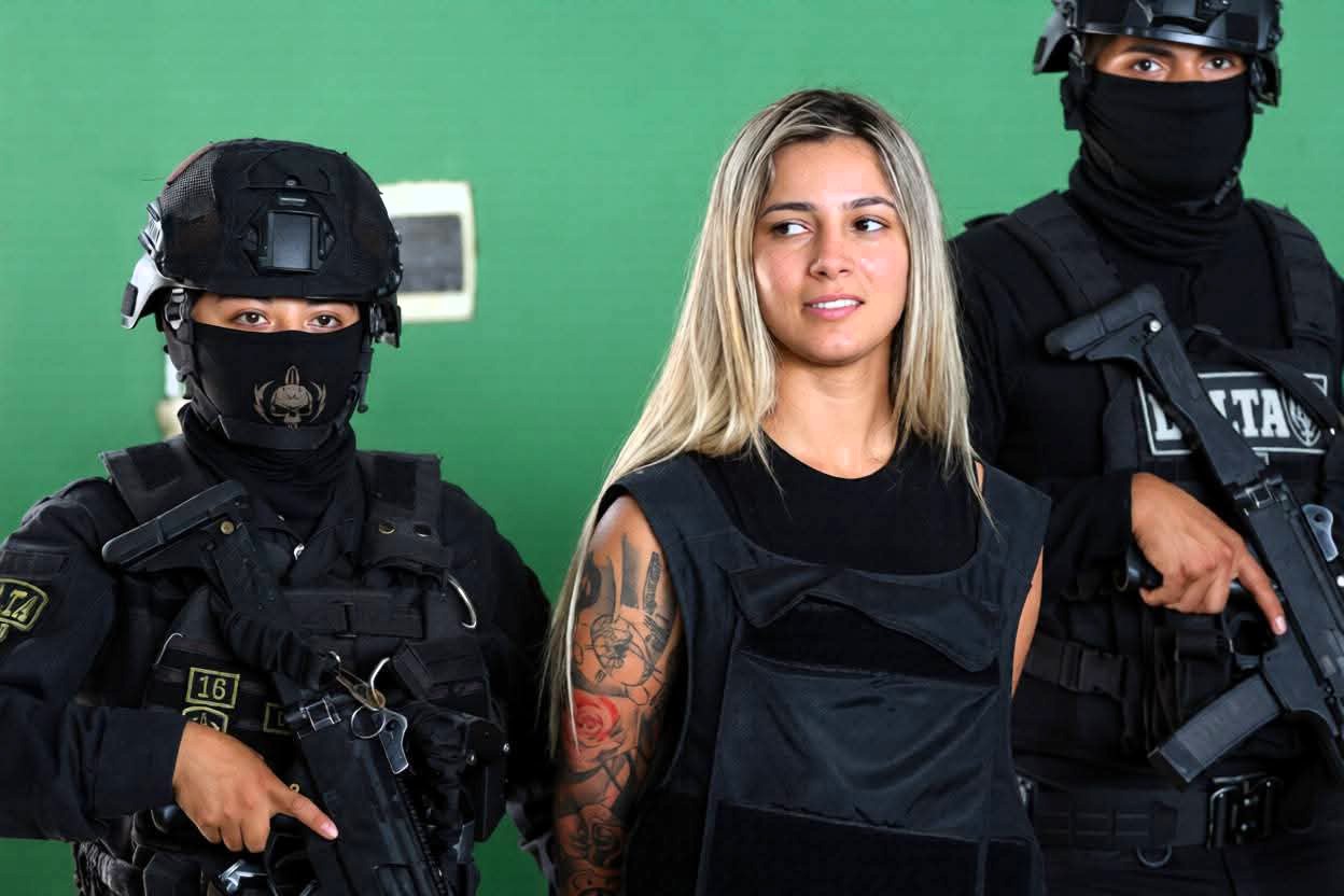 Glam narco suspect goes viral for smugly grinning in her arrest video - the 22-year-old is accused of being a senior member of her drug lord half-brother's criminal gang.