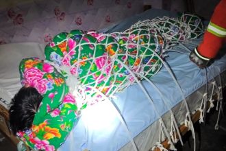 Hapless Houdini rescued by firefighters after tying himself up in a fishing net and cable ties for a viral escape challenge - only to end up stuck on his bed unable to move.