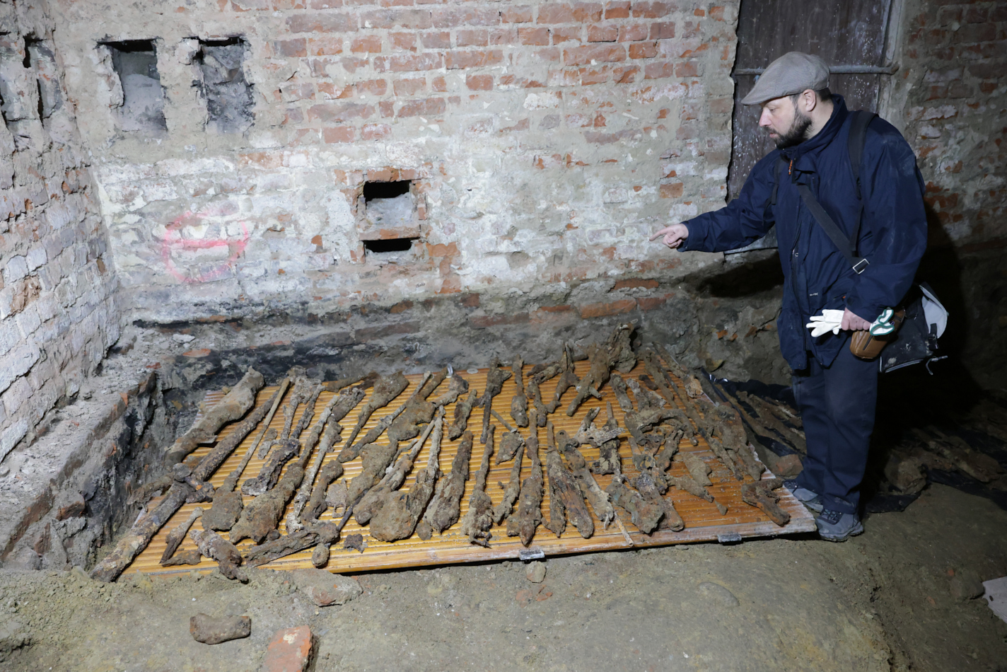 A hidden cache of World War-era weapons is discovered in a museum basement, prompting a major investigation as experts uncover decades-old firearms and live ammunition