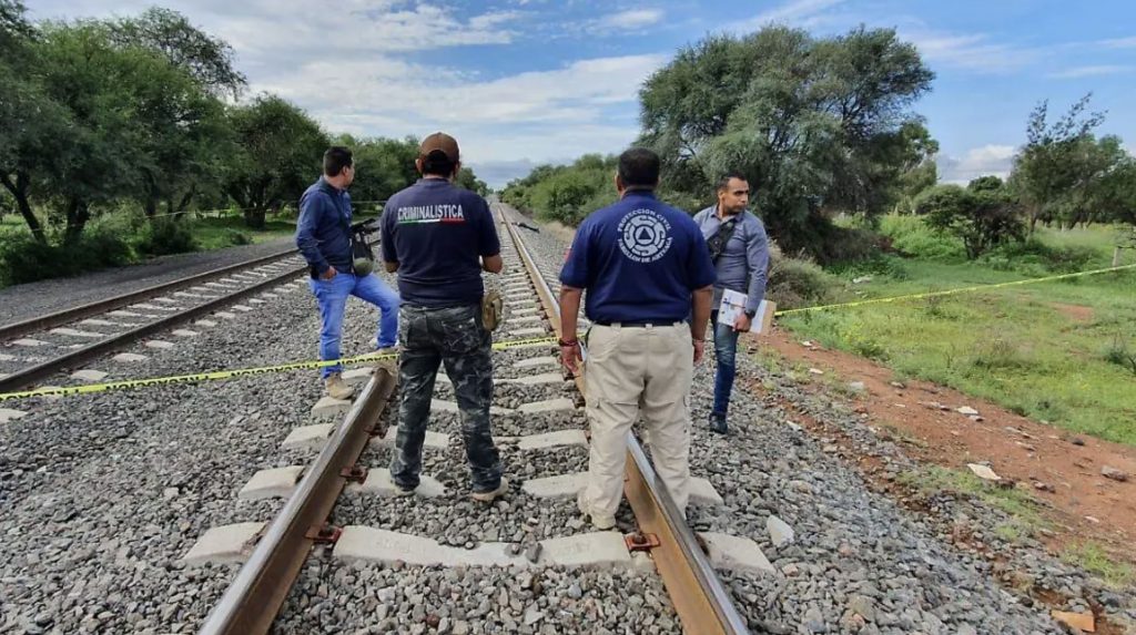 A freight train derailed after suspected track theft, killing one and injuring seven migrants as carriages plunged down an embankment in a dramatic crash now under investigation