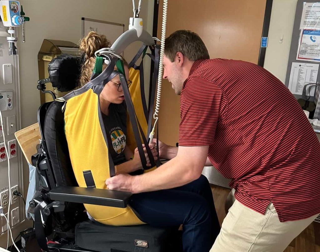 A woman woke up with tingling toes and was paralysed within days by a rare condition - now she has run a marathon and crossed the finish line with her daughter in her arms.