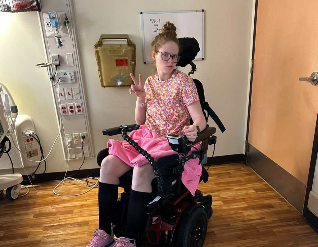 A woman woke up with tingling toes and was paralysed within days by a rare condition - now she has run a marathon and crossed the finish line with her daughter in her arms.