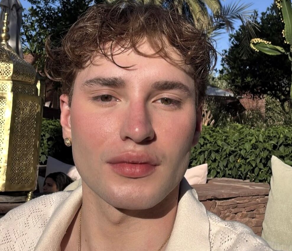 Police are hunting an influencer who allegedly posed as a young woman with cancer on a dating app and conned his online boyfriend out of £30,000 over more than two years.