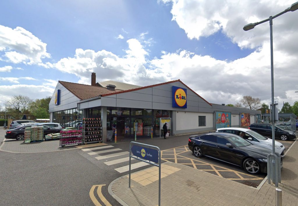 Shocking footage shows a suspected shoplifter smashing a bottle at security staff in a Lidl store in West London before threatening to put a bullet in them as shoppers watch.