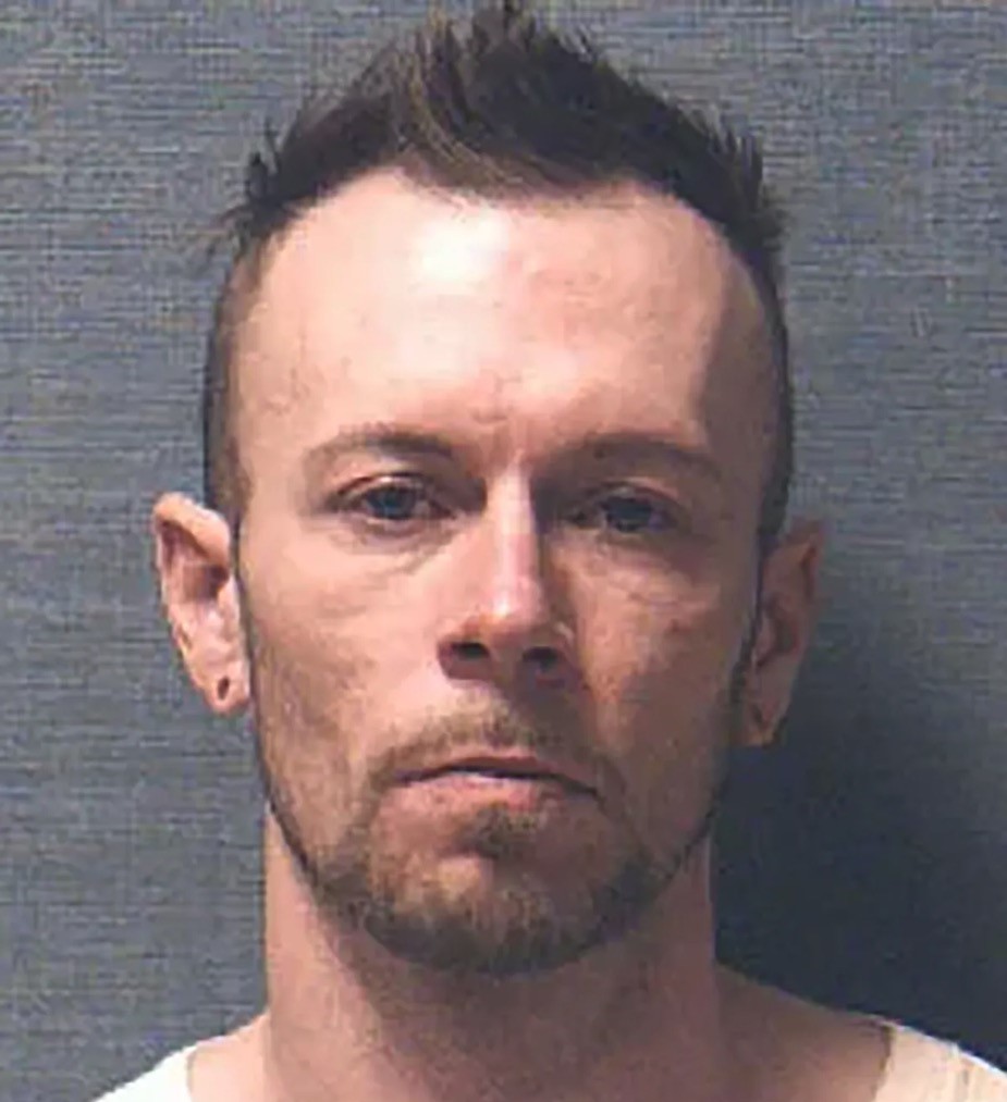 A man who killed his baby son is arrested on a beach while smiling at police, as officers uncover his past and move to extradite him over parole violations