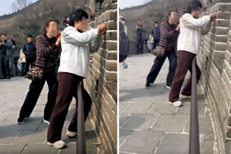 Two women arrested after one was caught on camera carving their names into the Great Wall of China with scissors - while her companion brazenly filmed the whole thing.