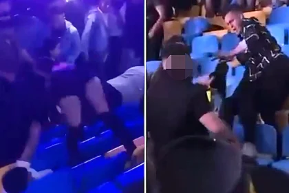 Woman thrown from the stands by her hair during a massive brawl at a Grupo Firme concert in Honduras - as footage shows men exchanging punches and kicks in tiered seating.