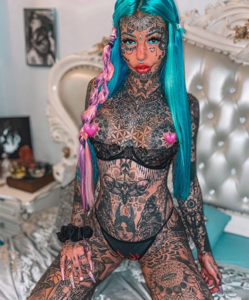 Australia's most tattooed woman halts her plans to remove 36 tattoos after using AI to see her bare face - saying she was completely freaked out by what she saw.