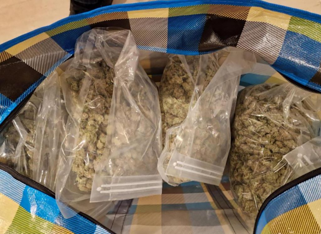 A drug dealer is caught with thousands in cash after giving a flimsy excuse at a train station, with police later uncovering a £35,000 cannabis stash at his home.