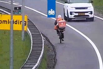 Bungling food delivery rider spotted cycling along the hard shoulder of a busy motorway in the Netherlands - prompting a hilarious warning from traffic authorities online.