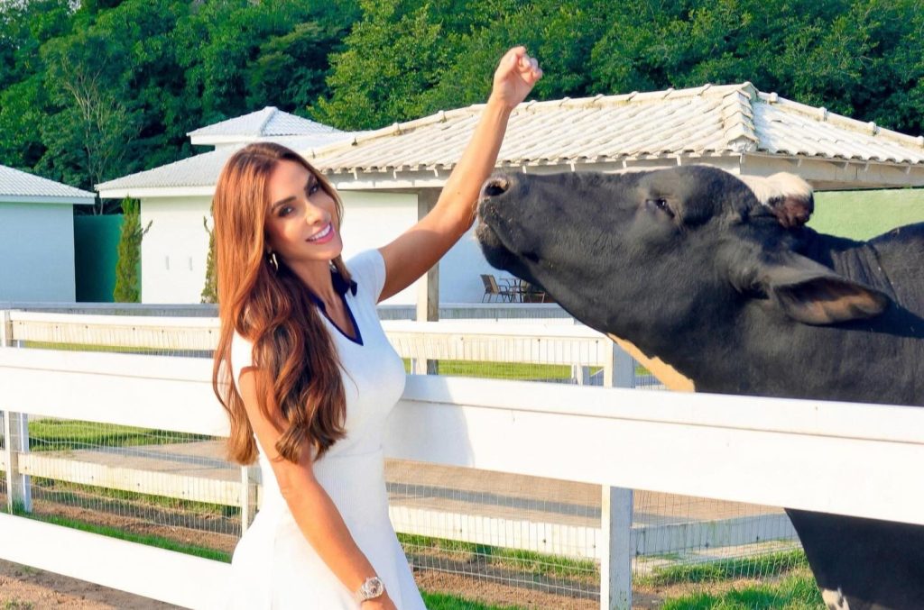 A Brazilian model with 31 million followers was sent flying into a water trough by her own cow while dancing on her ranch - and the whole thing was caught on camera.