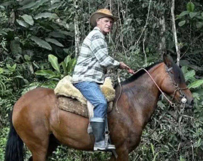 A horse was caught on camera letting out a heartbreaking whinny and nudging her owner's body at his wake - after his daughter brought her along to say her final goodbye.