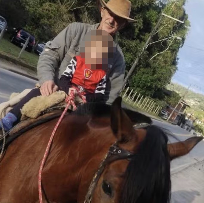 A horse was caught on camera letting out a heartbreaking whinny and nudging her owner's body at his wake - after his daughter brought her along to say her final goodbye.