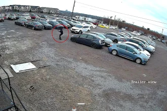 A masked gunman fired 16 shots at a Canadian car dealership in broad daylight before fleeing in a waiting Honda, with police offering a reward for information on the suspects.