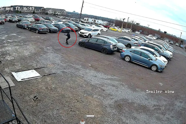 A masked gunman fired 16 shots at a Canadian car dealership in broad daylight before fleeing in a waiting Honda, with police offering a reward for information on the suspects.