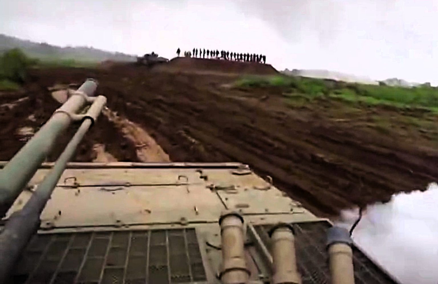 Soldier accidentally fires a smoke grenade at senior military officials during a training exercise - sending them scrambling as the leaked helmet cam footage goes viral.