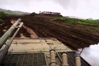 Soldier accidentally fires a smoke grenade at senior military officials during a training exercise - sending them scrambling as the leaked helmet cam footage goes viral.