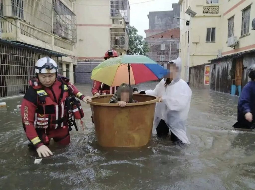 More than 100 cars were left submerged and streets turned into flood zones after the strongest rainstorm in a decade struck the city of Qinzhou in China.