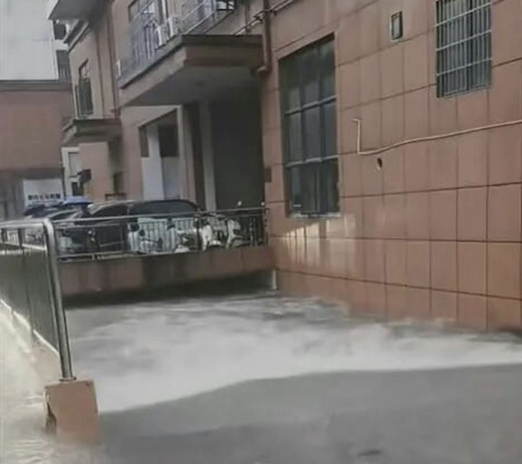 More than 100 cars were left submerged and streets turned into flood zones after the strongest rainstorm in a decade struck the city of Qinzhou in China.